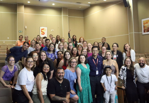 Foto do grupo de participantes do encontro com os Comitês de Impacto Social do Instituto BRF no auditório da unidade da BRF em Jundiaí. Todos sorriem.